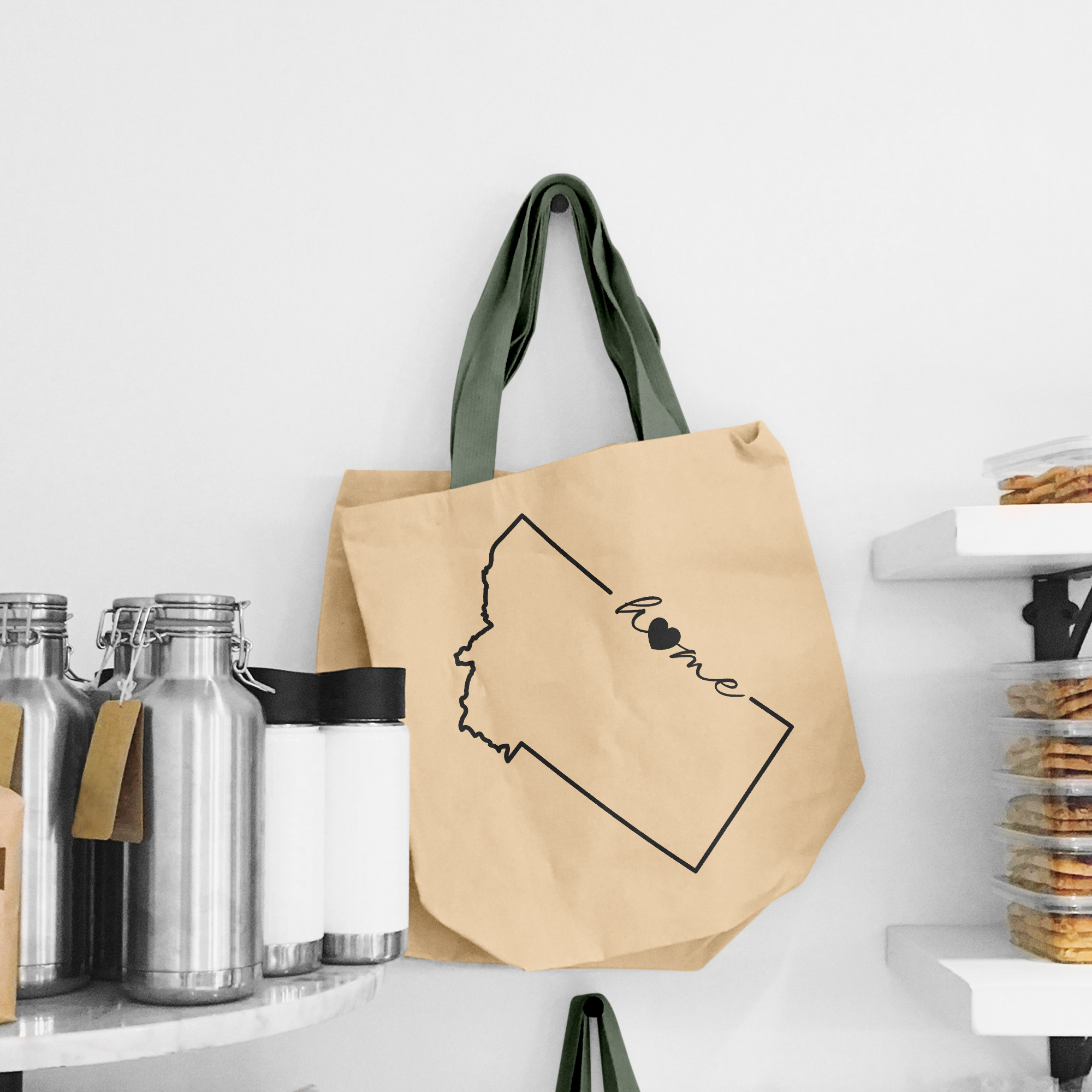 Black illustration of map of Montana on the beige shopping bag with dirty green handle.