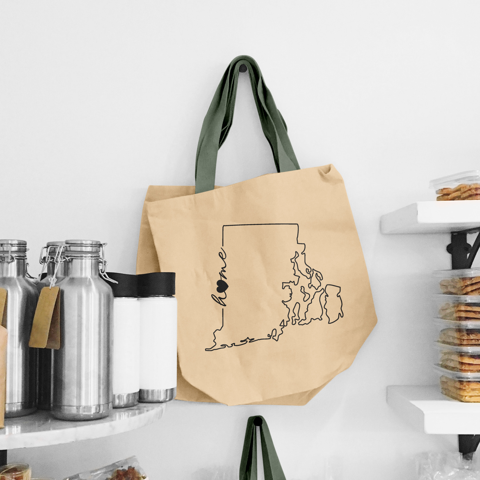 Black illustration of map of Rhode Island on the beige shopping bag with dirty green handle.