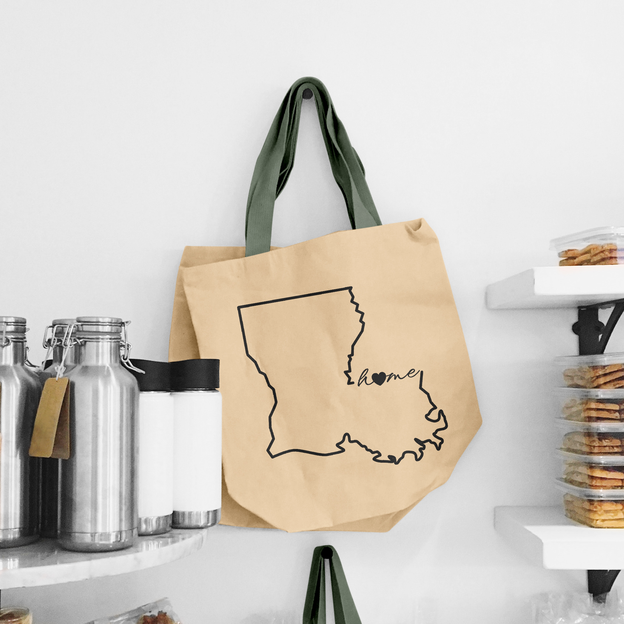 Black illustration of map of Louisiana on the beige shopping bag with dirty green handle.