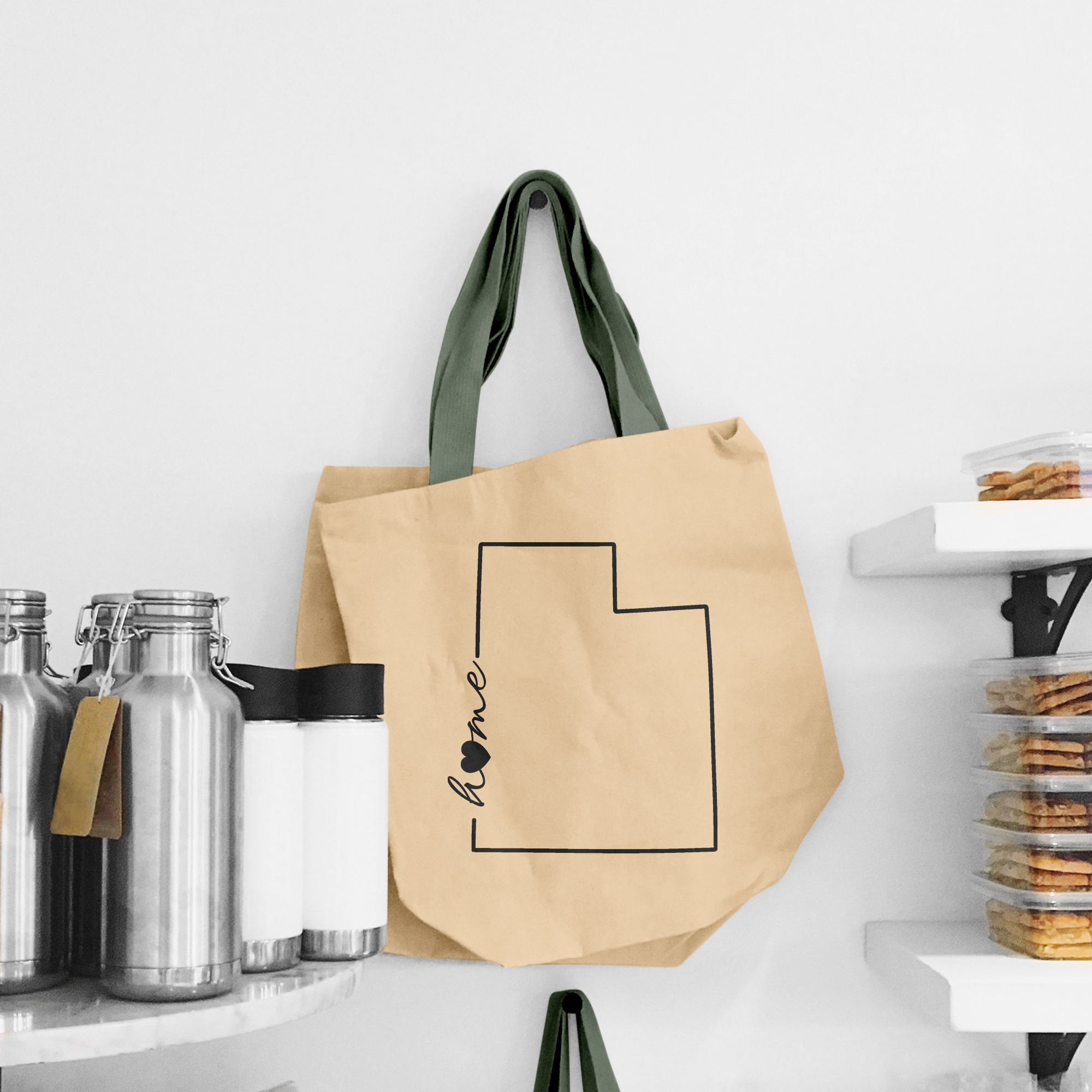 Black illustration of map of Utah on the beige shopping bag with dirty green handle.