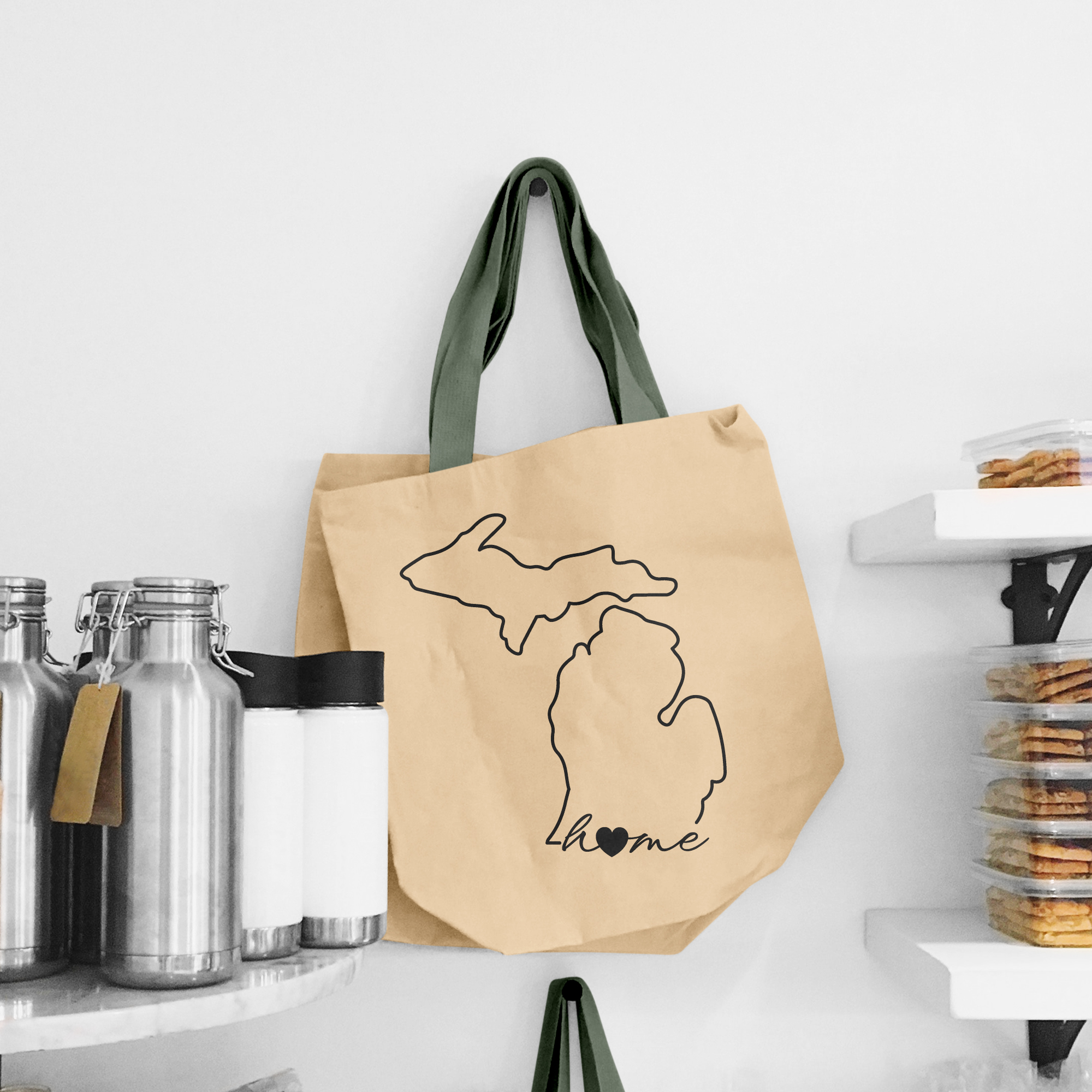 Black illustration of map of Michigan on the beige shopping bag with dirty green handle.