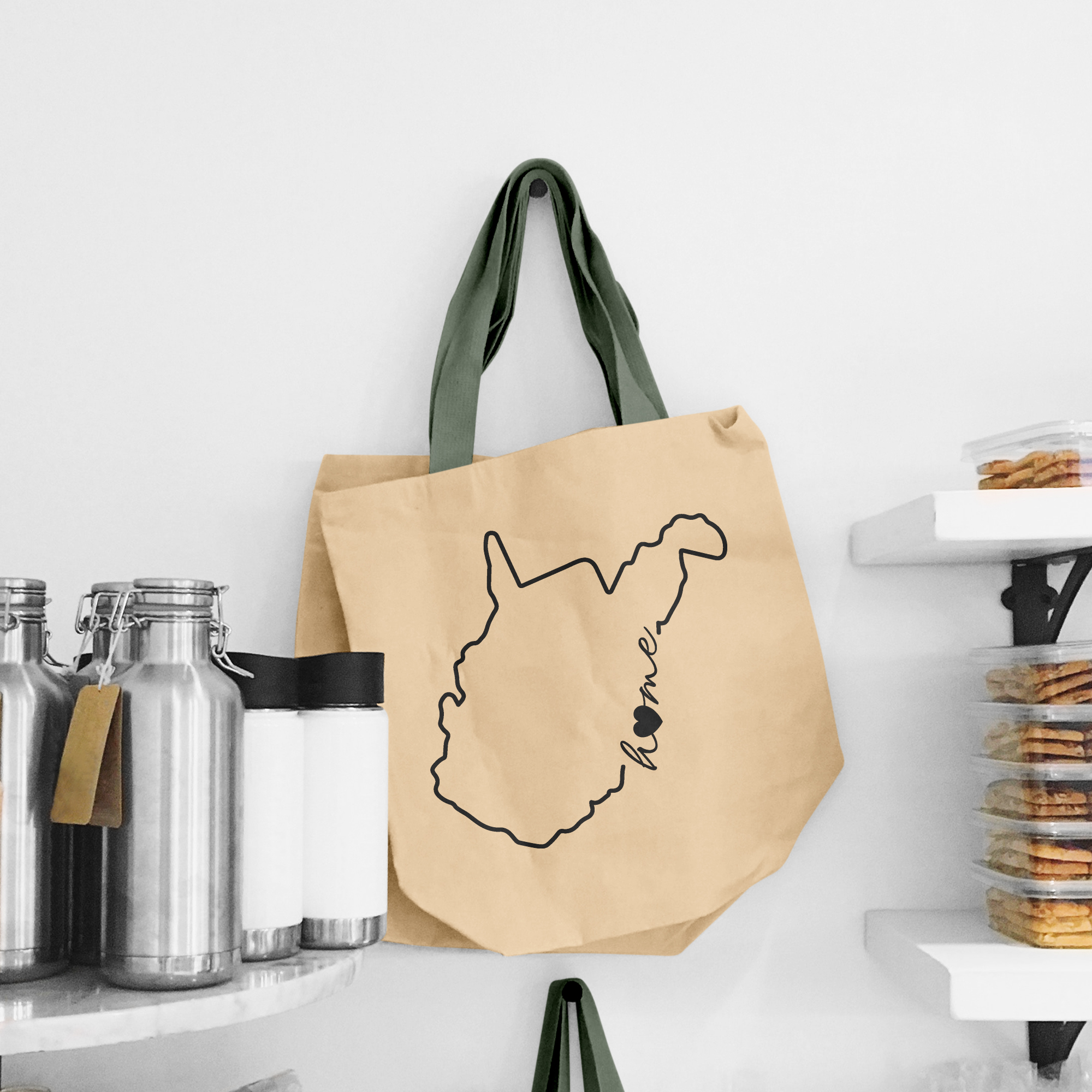 Black illustration of map of West Virginia on the beige shopping bag with dirty green handle.