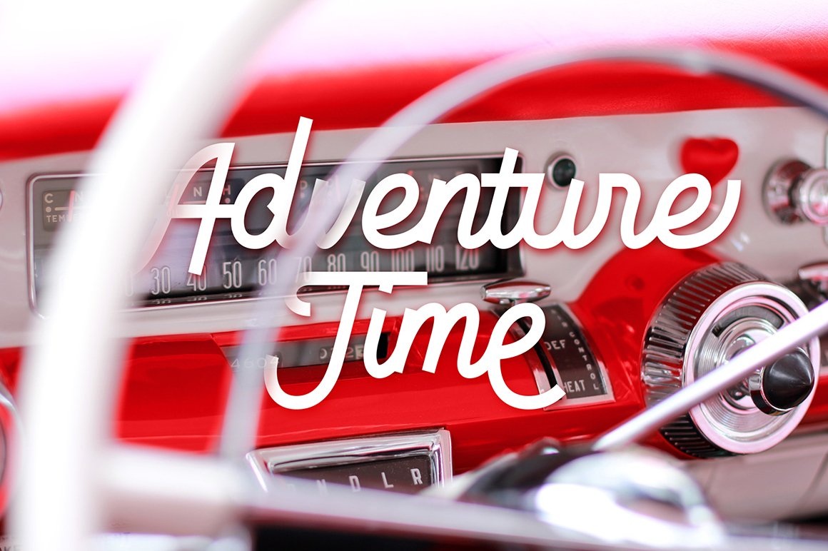 White lettering "Adventure time" on the background of car.