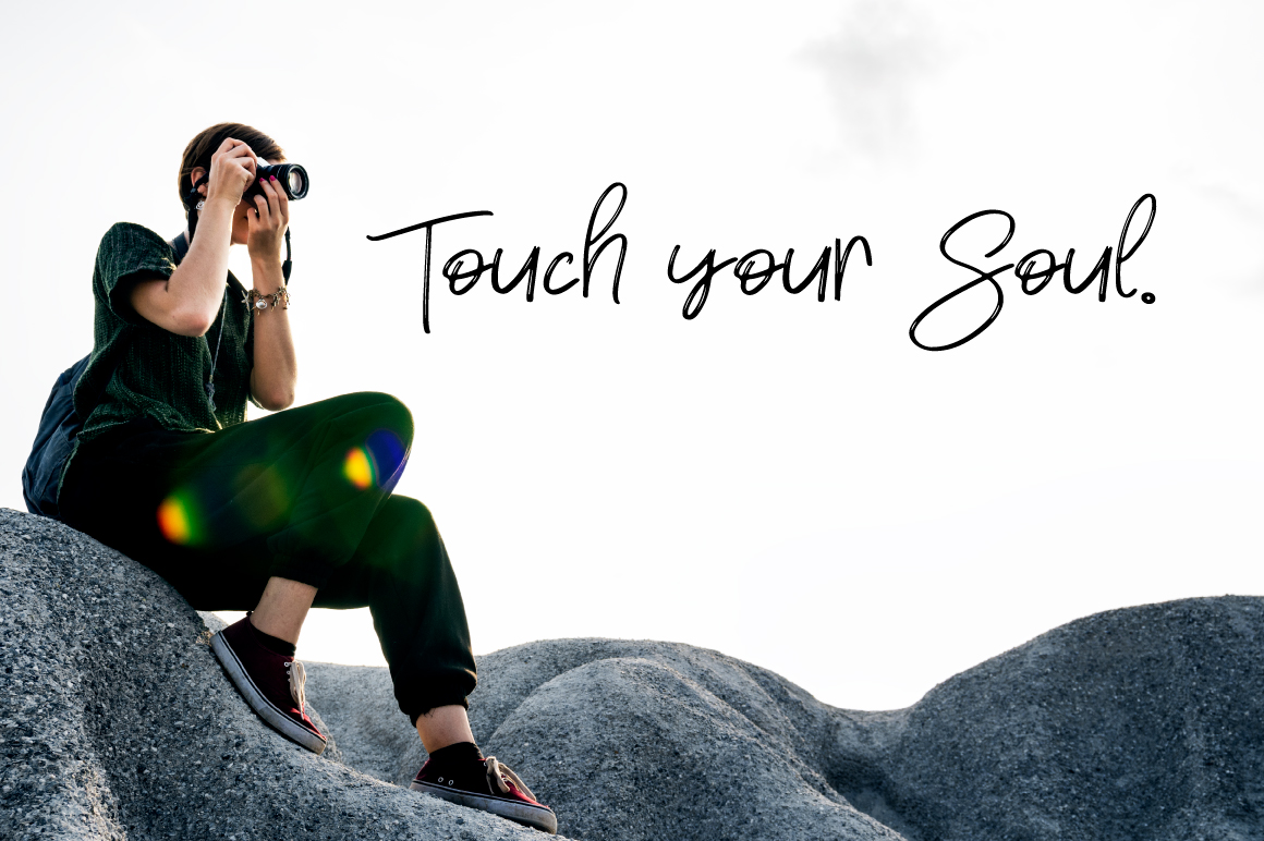 Black script lettering "Touch your soul" and image of photographer.