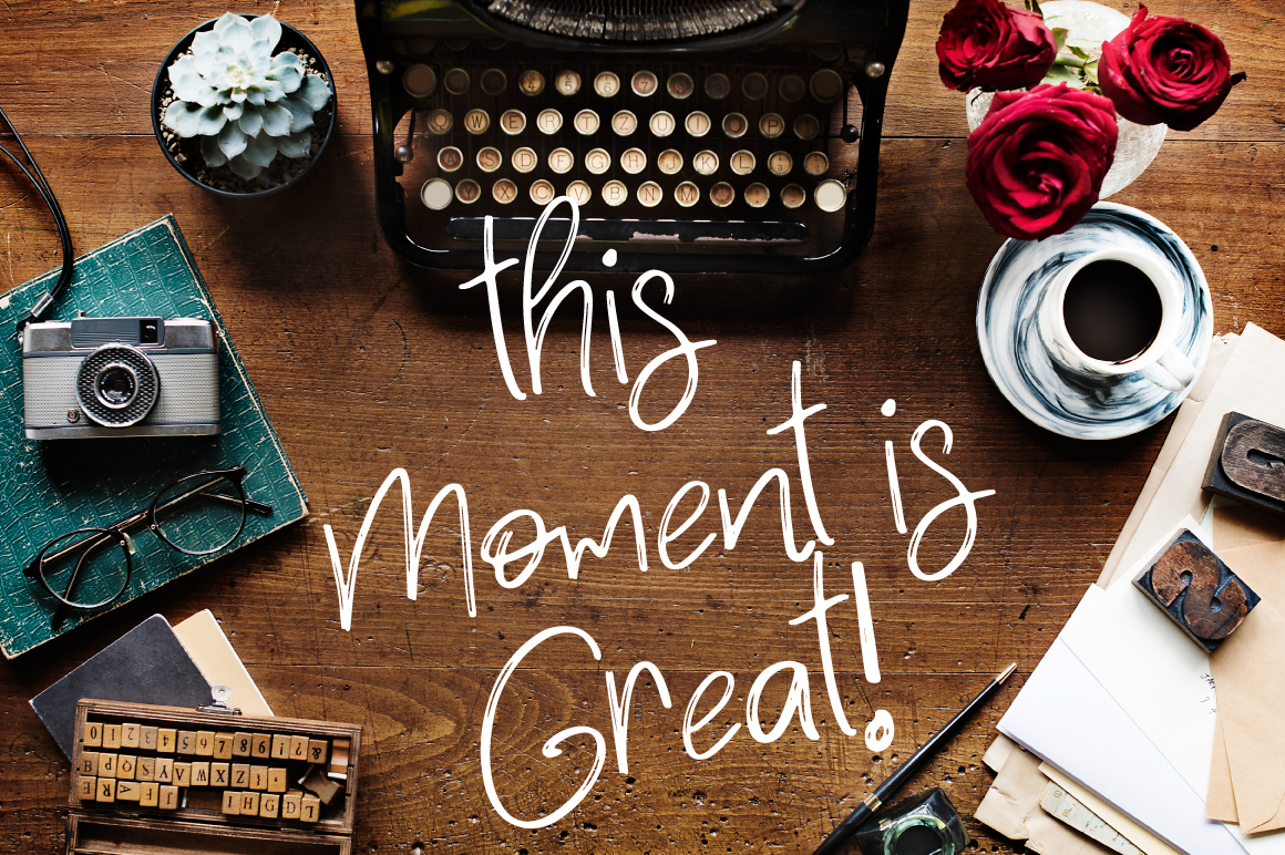 White calligraphy lettering "This moment is great!".