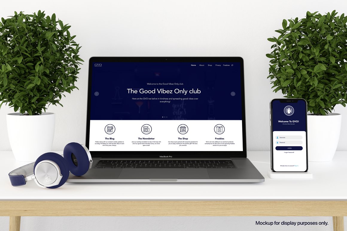 Headphones, macbook and iphone mockups with blue and white template on the table.