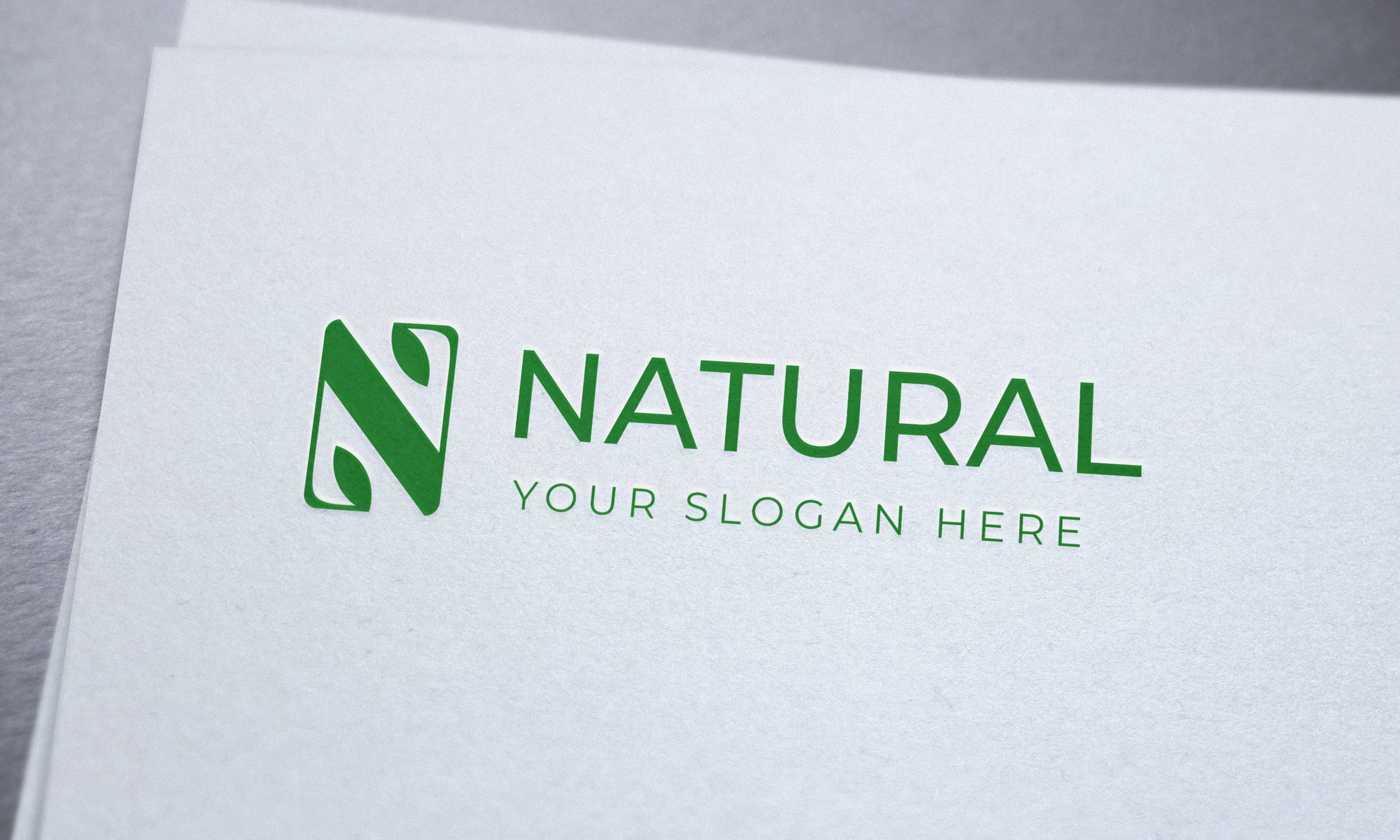Green eco logo on a light paper.