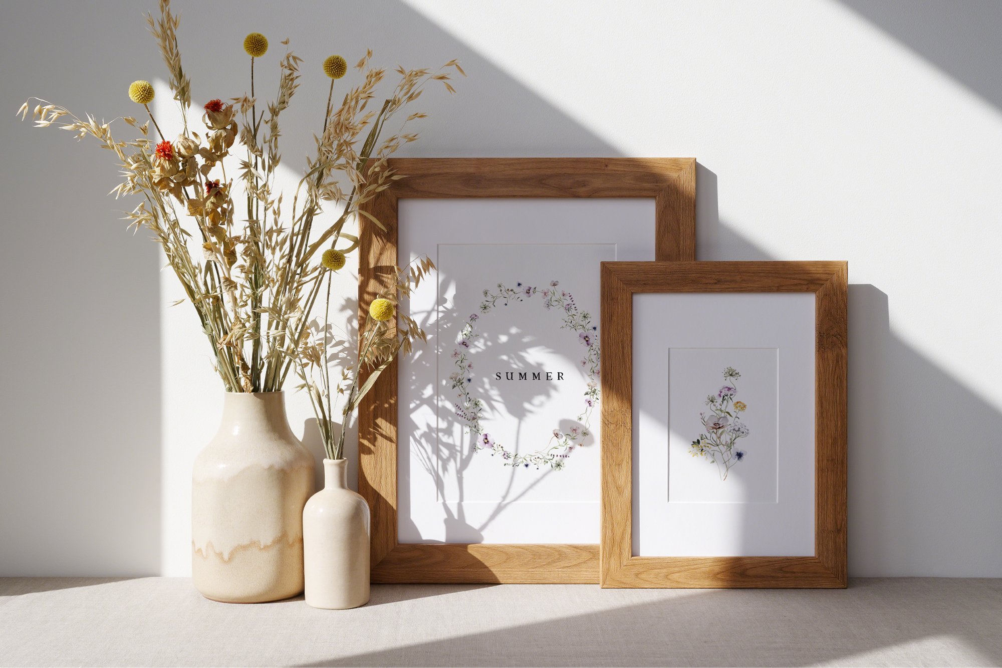 Two posters with flowers and in wooden frames.