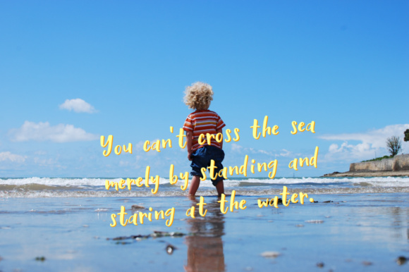 Yellow lettering in Ooh Lala font on the background of child on the beach.