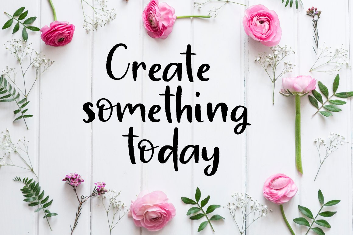 Lettering "Create sommething today" in black calligraphy font on a background with pink flowers.