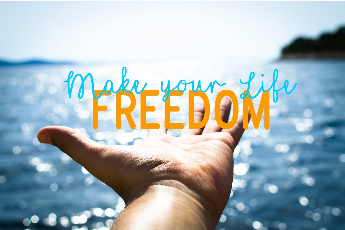Blue and orange lettering "Make your life Freedom" on the background of hand and sea.