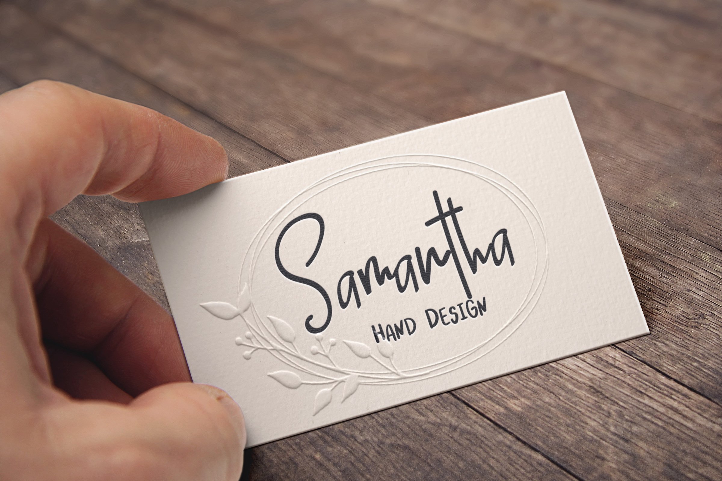 Delicate white business card with name lettering.