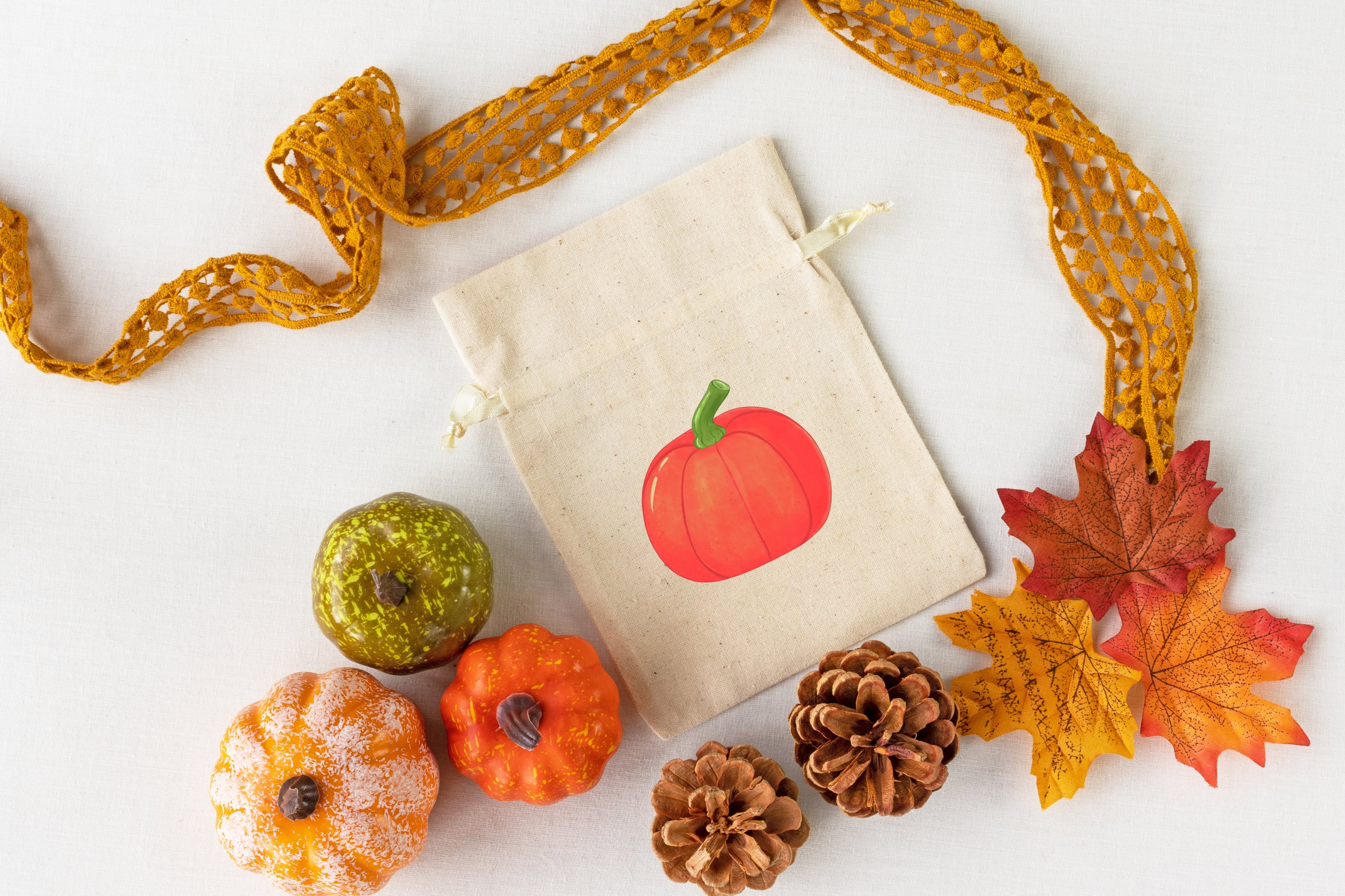 Beige bag with illustration of pumpkin on a gray background with pumkins.