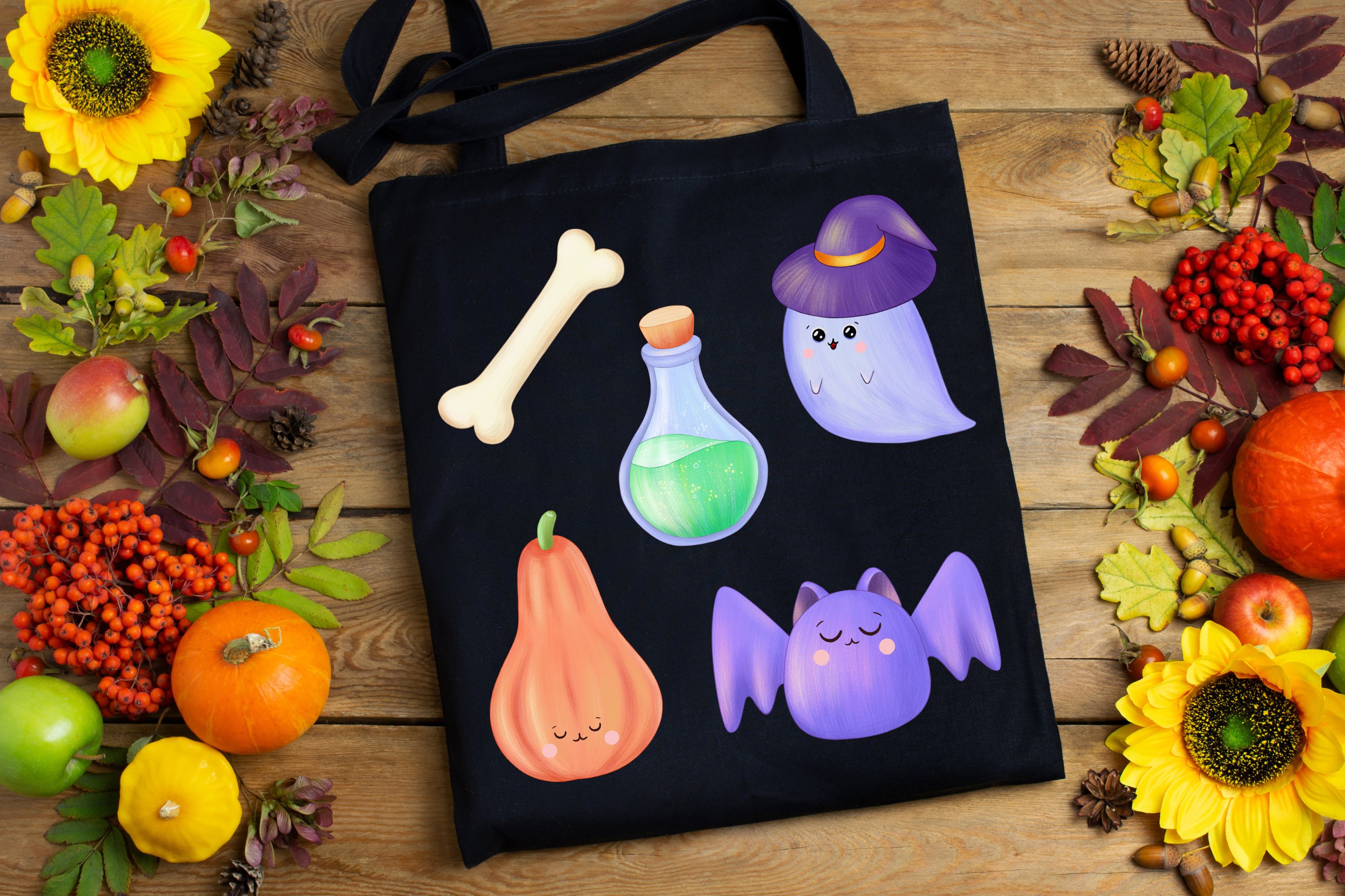 Black printable shopping bag with halloween illustrations on the wooden background with different halloween objects.