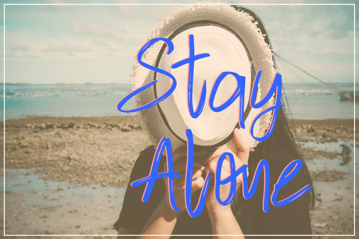 Blue lettering "Stay Alone" on the background of a girl on the beach.