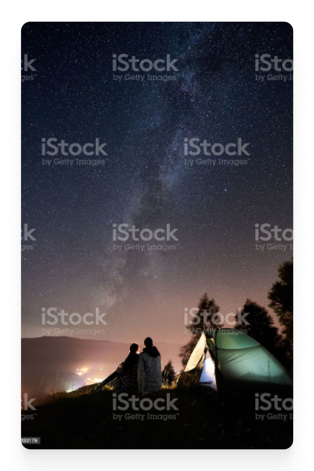 Photo of a tent and a couple in her against the background of a starry sky.