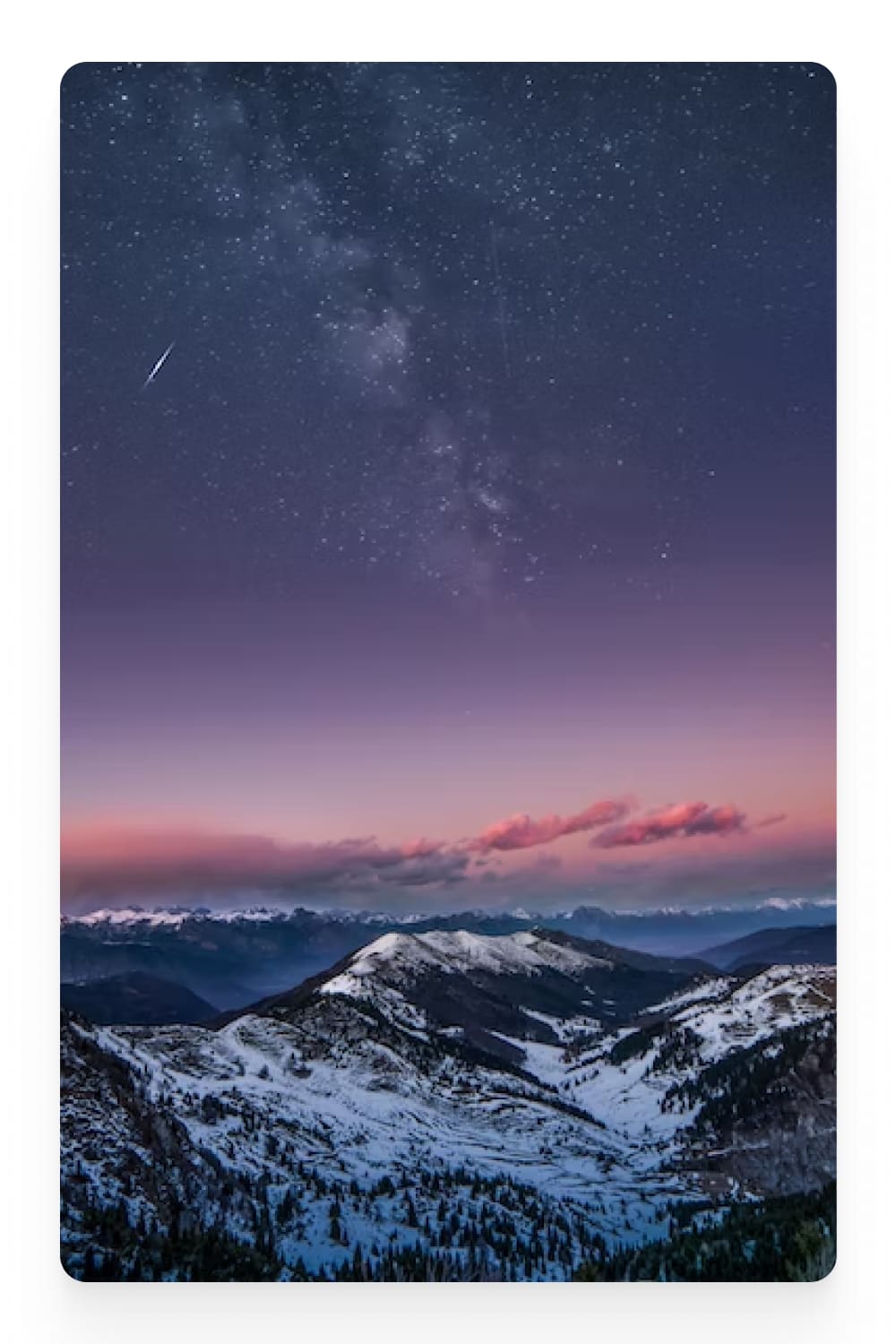 Photo of a snowy forest in the mountains against the background of a starry sky.