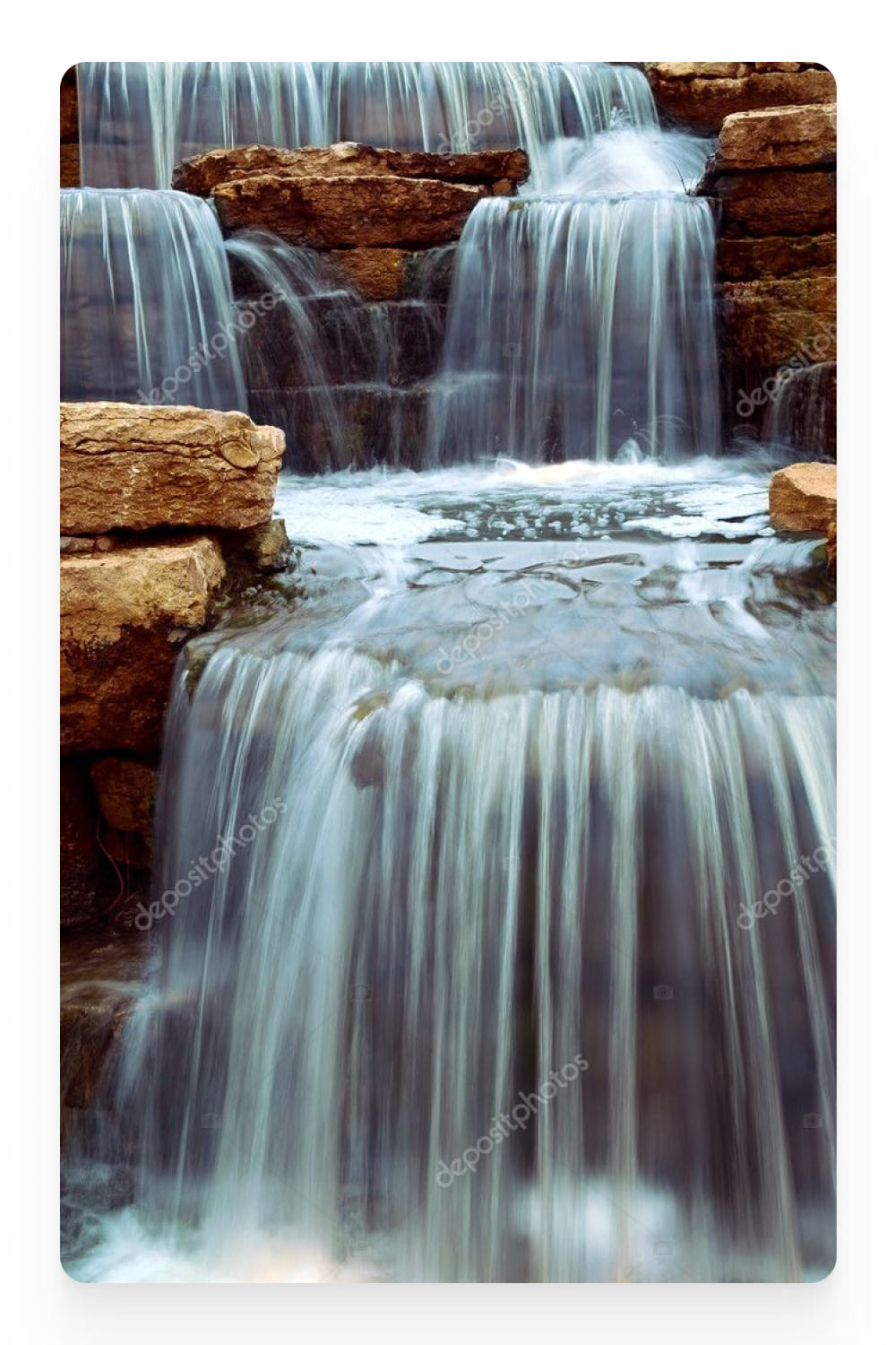 Photo of a small waterfall in several steps.