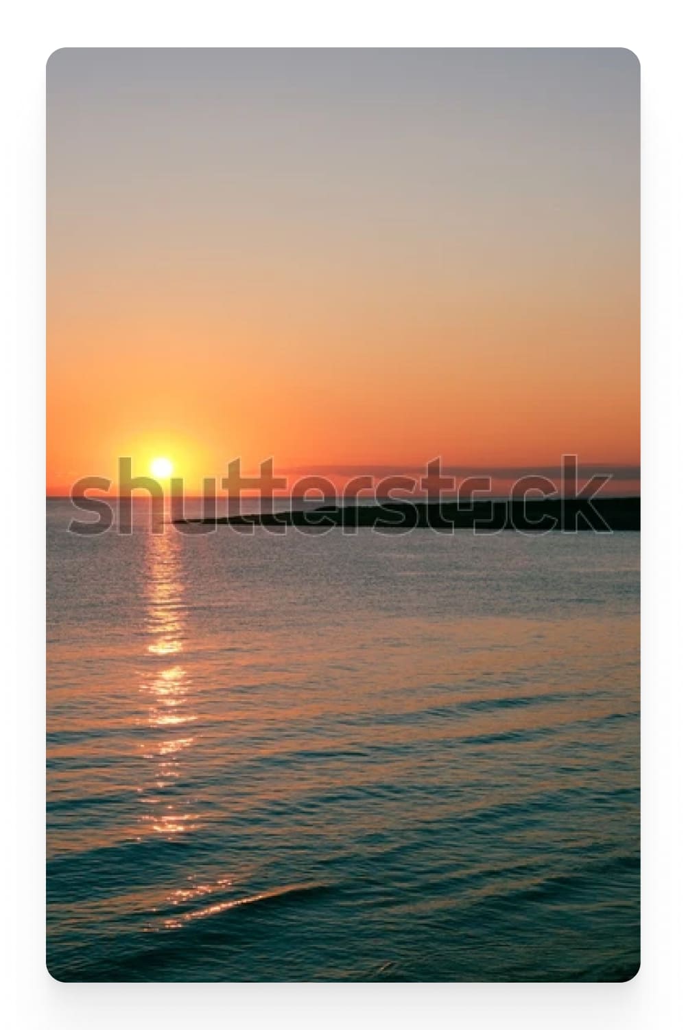 Photograph of a calm sea at sunset.