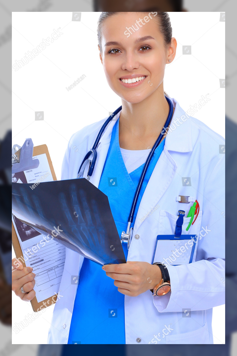 Young female doctor looking at the x ray picture isolated on white background.
