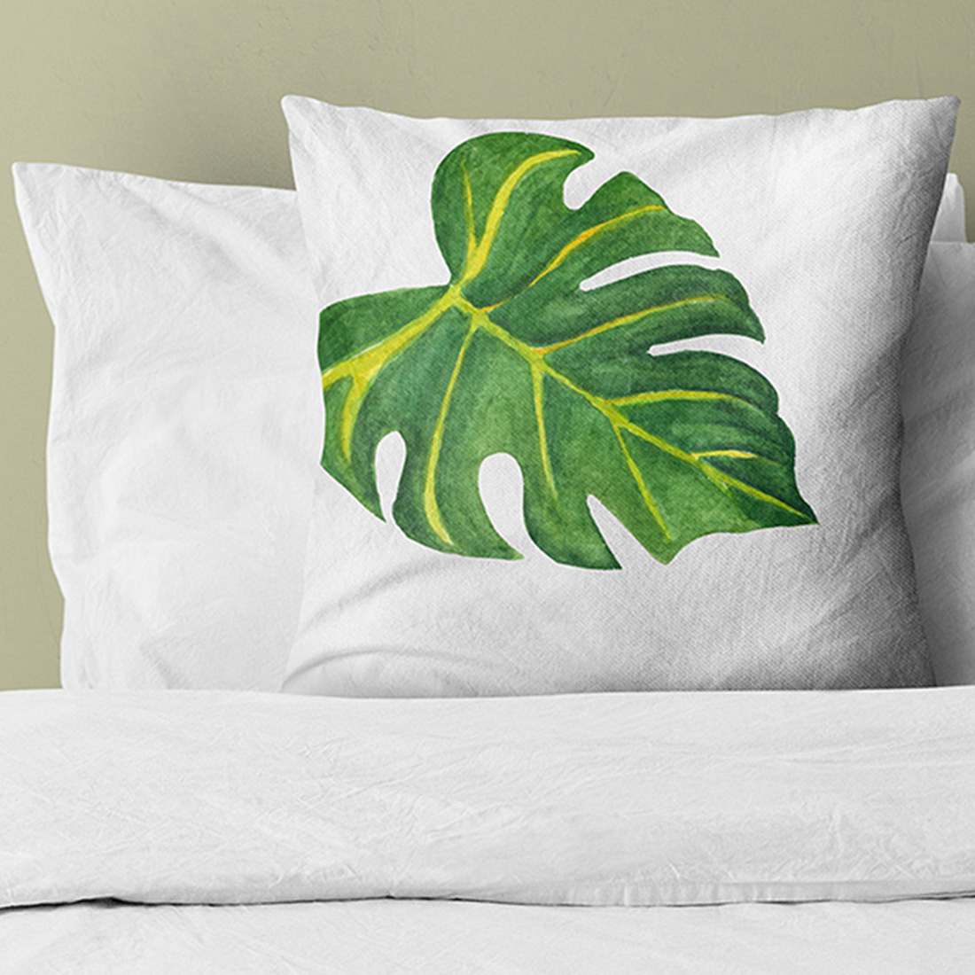 White pillow with green leaves.