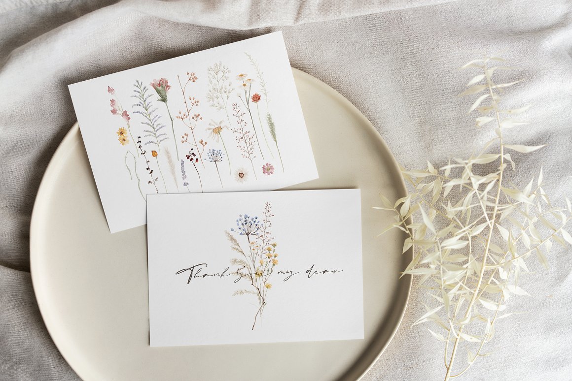 2 white cards with flowers illustrations and black lettering.