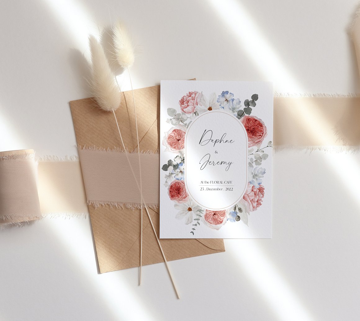 Wedding vertical card with floral composition and black lettering and craft envelope.