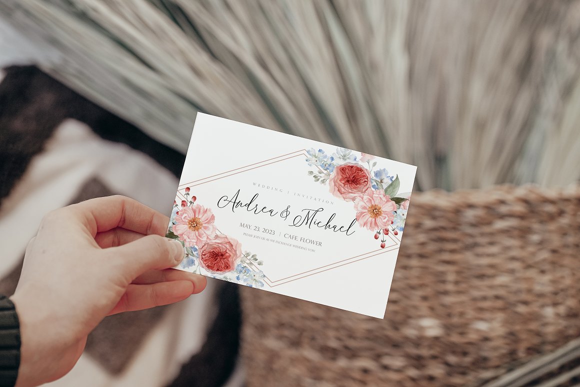 Horizontal wedding card with black lettering and 2 flower compositions.