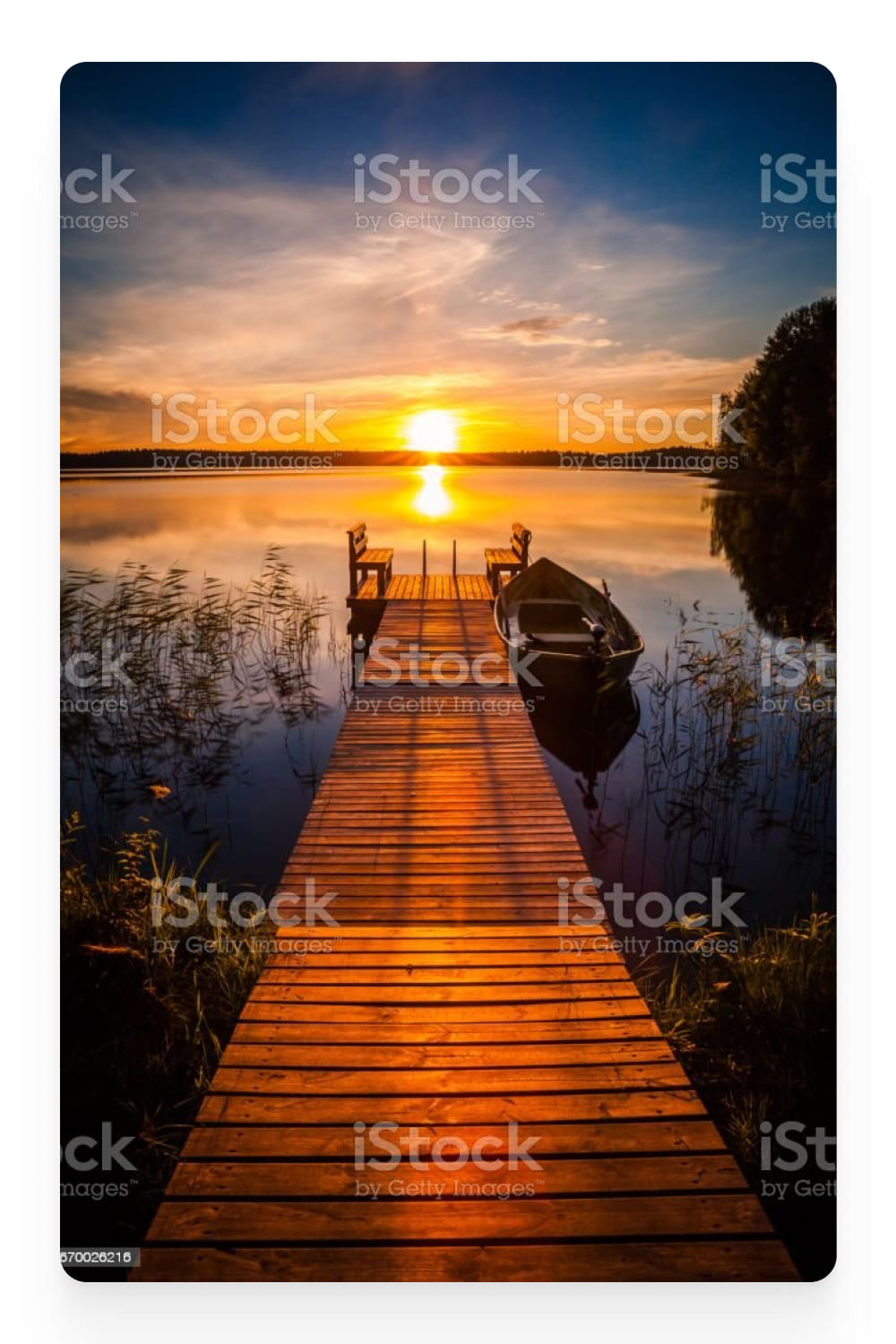 Photo of the pier in the lake and the sunset.