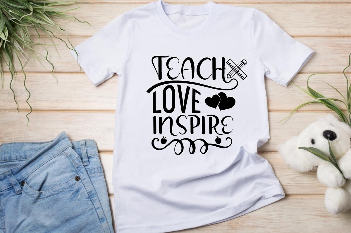 Motivated teacher lettering on a white t-shirt.