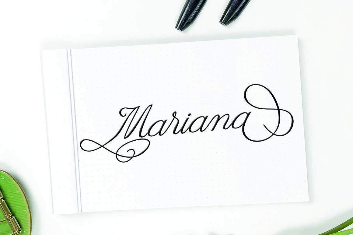 Black calligraphy lettering "Mariana" on a white sheet.