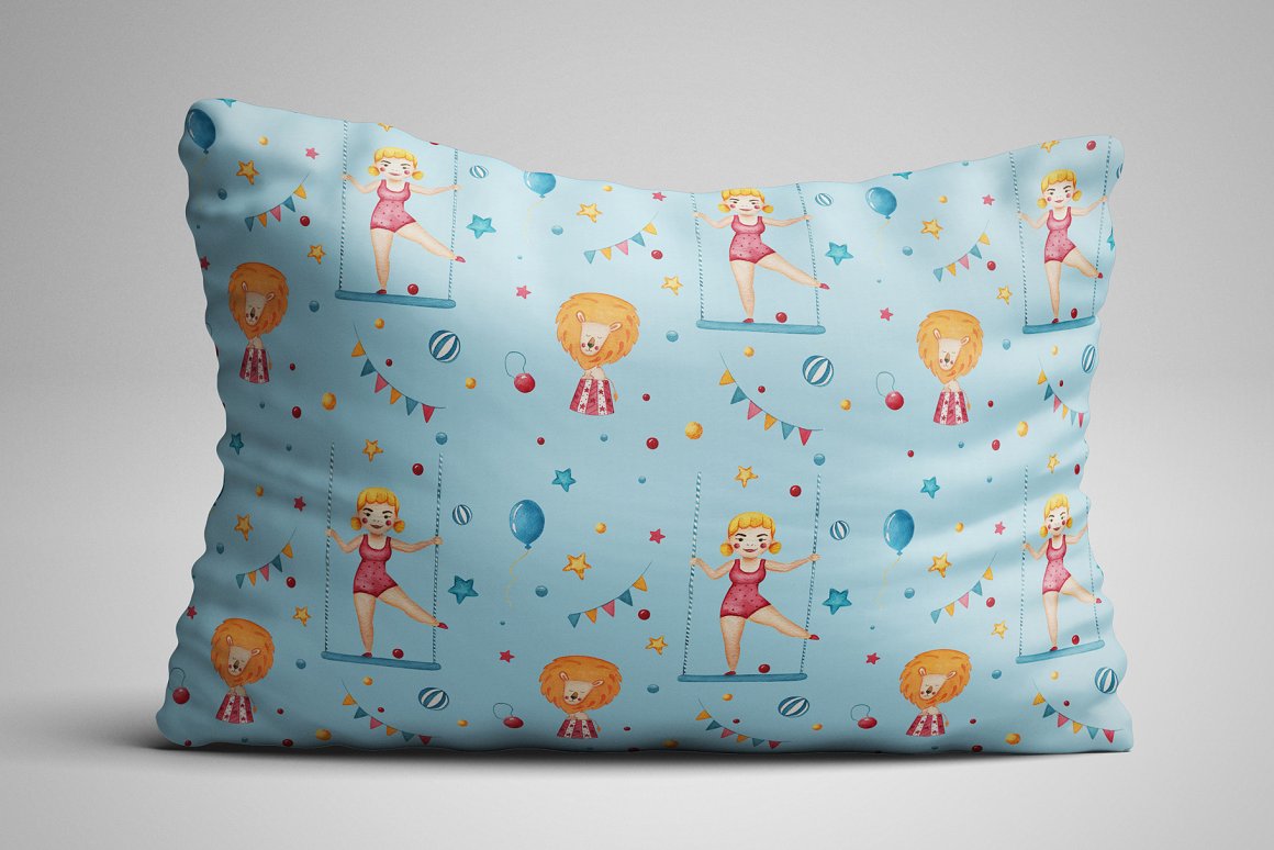 Light blue pillow with circus patterns on a gray background.