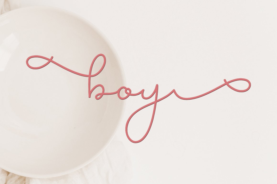Pink calligraphy lettering "boy" on a pink background.