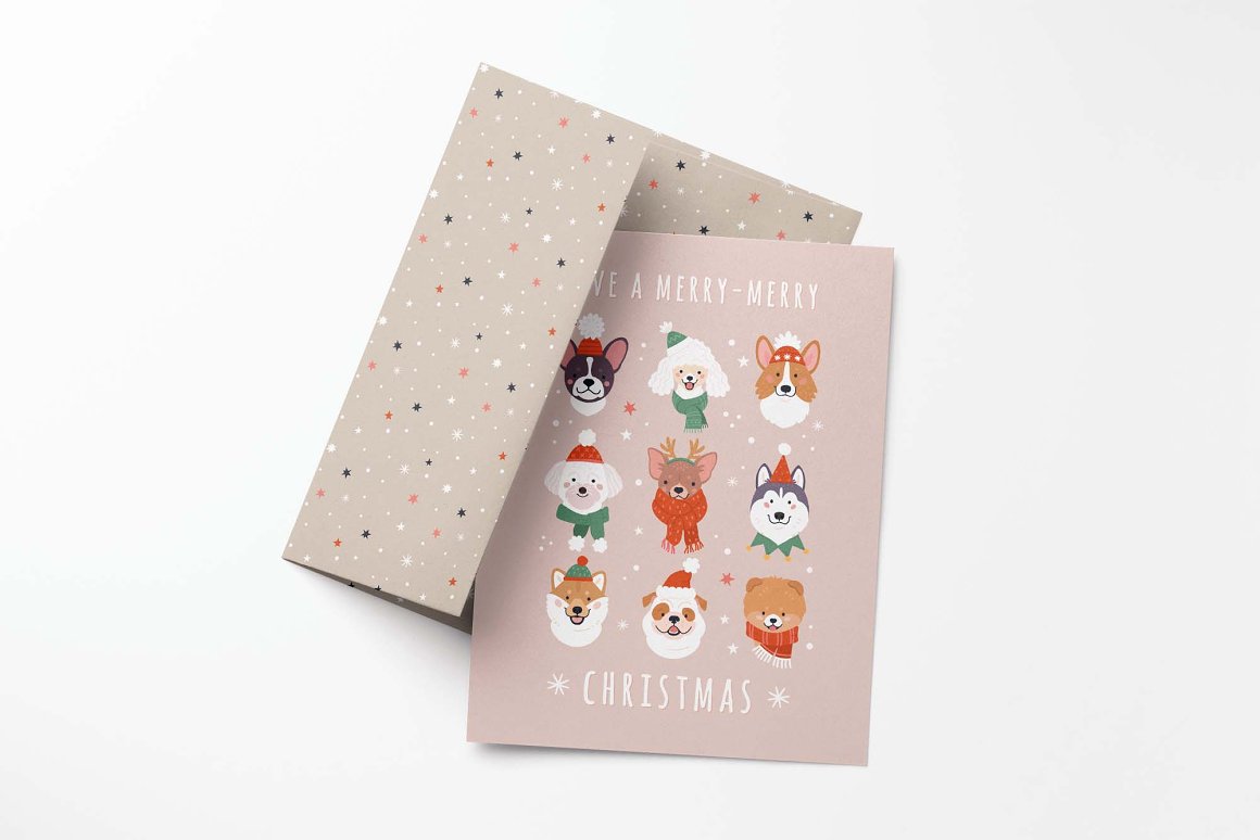 Pink greeting card with 9 christmas dogs illustrations and envelope on a gray background.