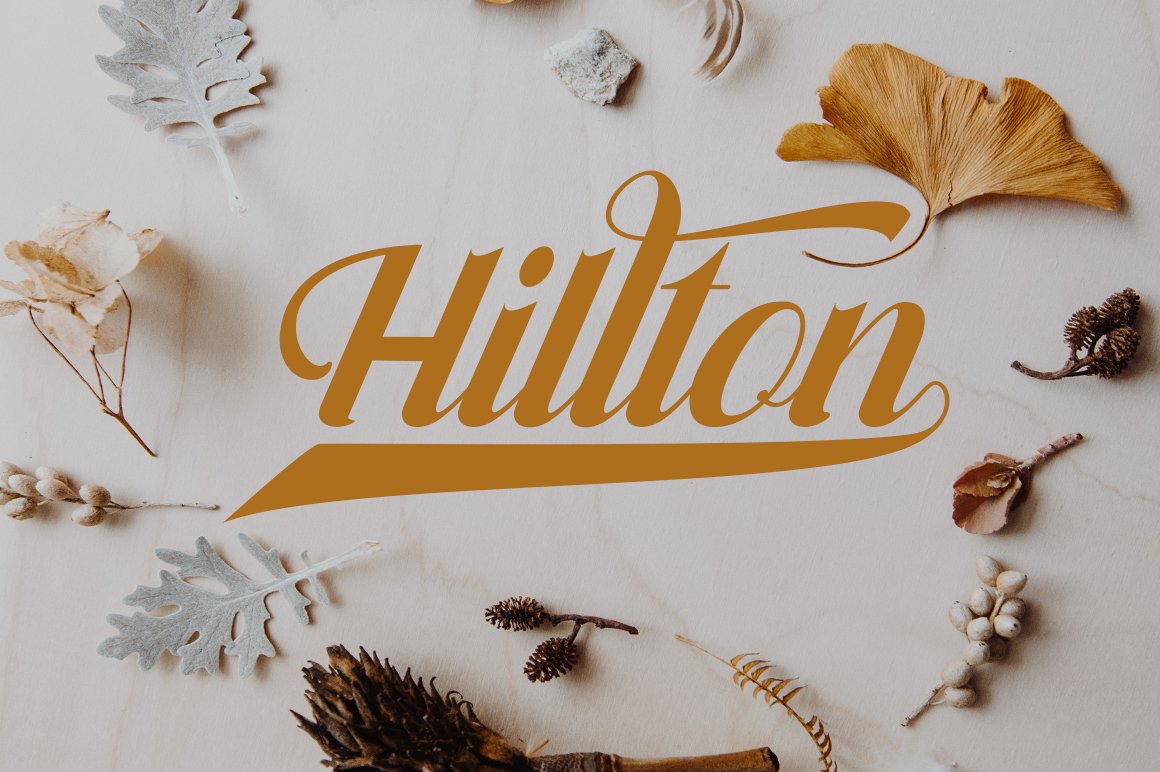 Dirty orange lettering "Hilton" on a gray background with different objects.