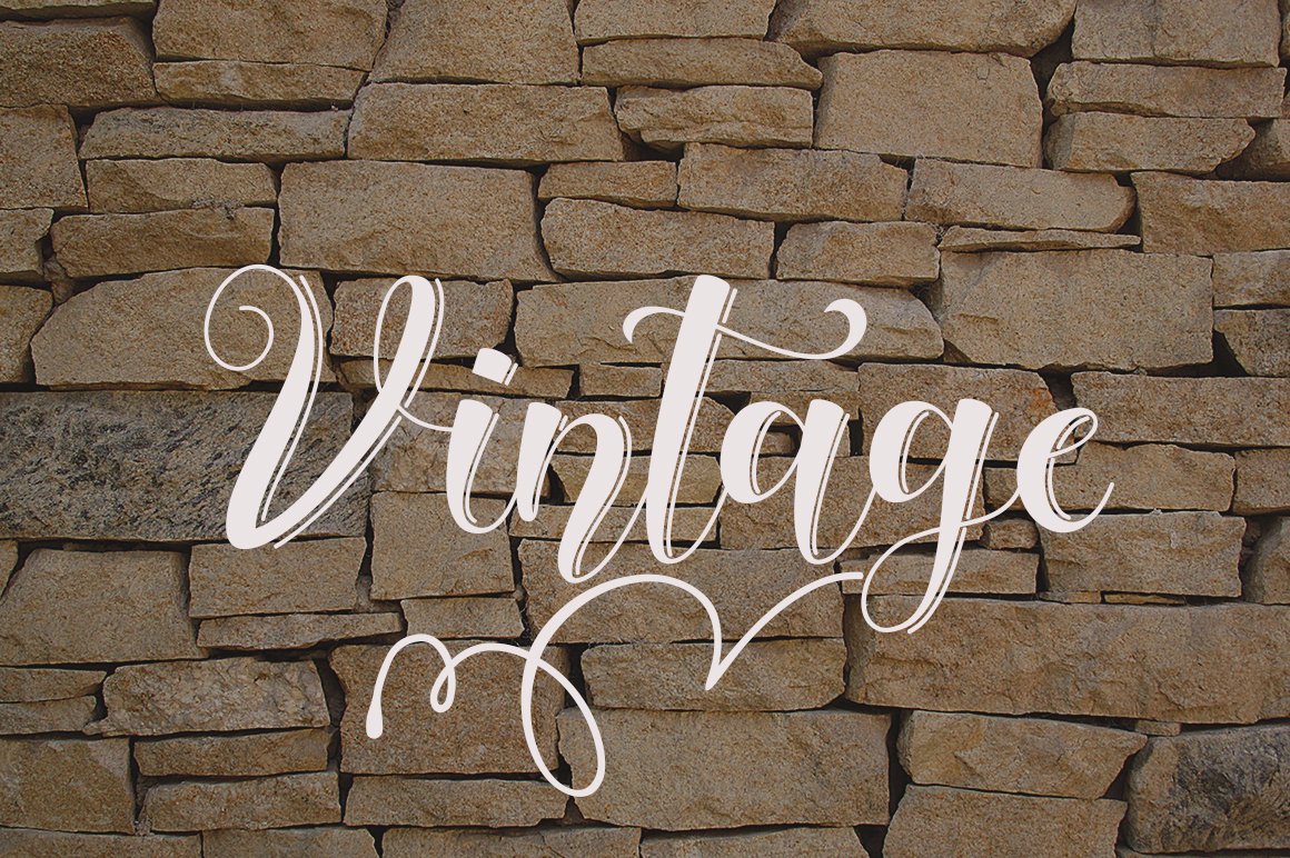 White calligraphy lettering "Vintage" on the background of stones.