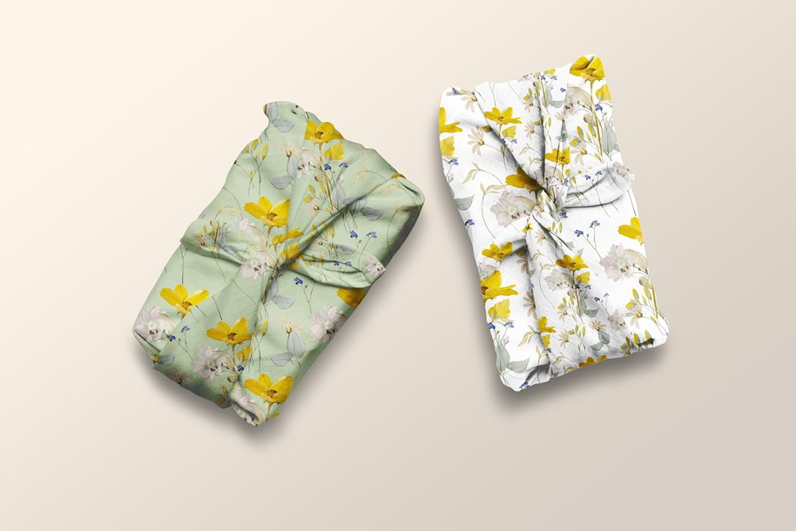 White and green fabric textiles with meadow flowers patterns.