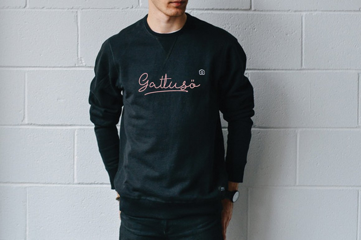 Black sweatshirt with pink calligraphy lettering on a man.