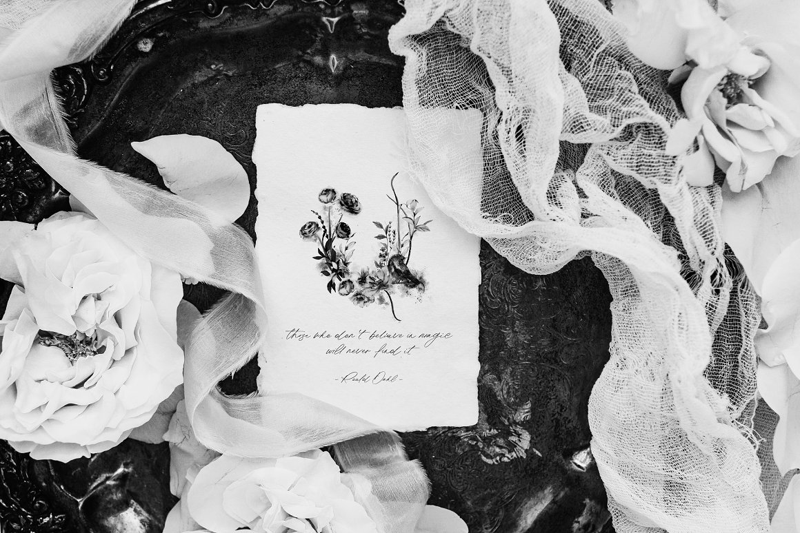 White card with black illustration of magical flowers.