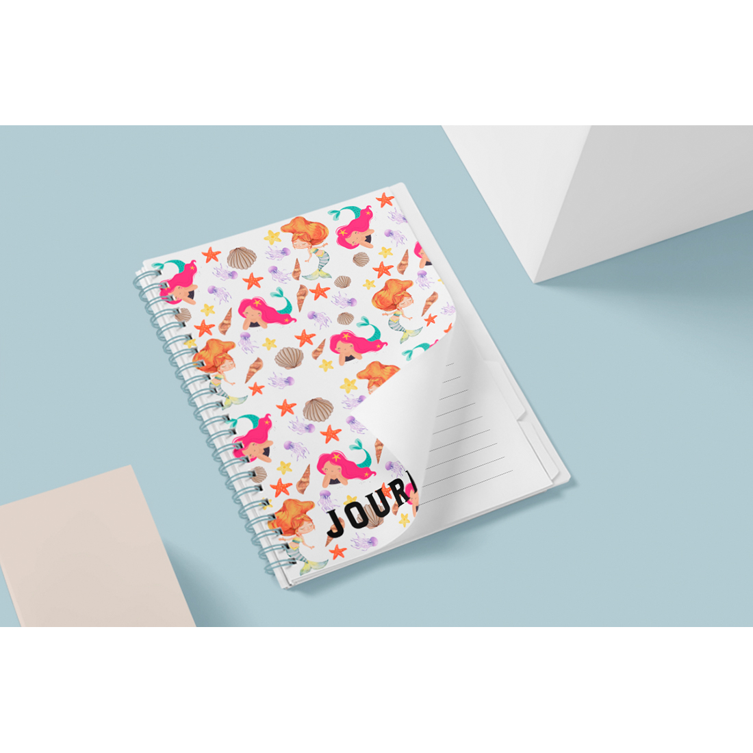 Image of notebook with enchanting cover with mermaid patterns