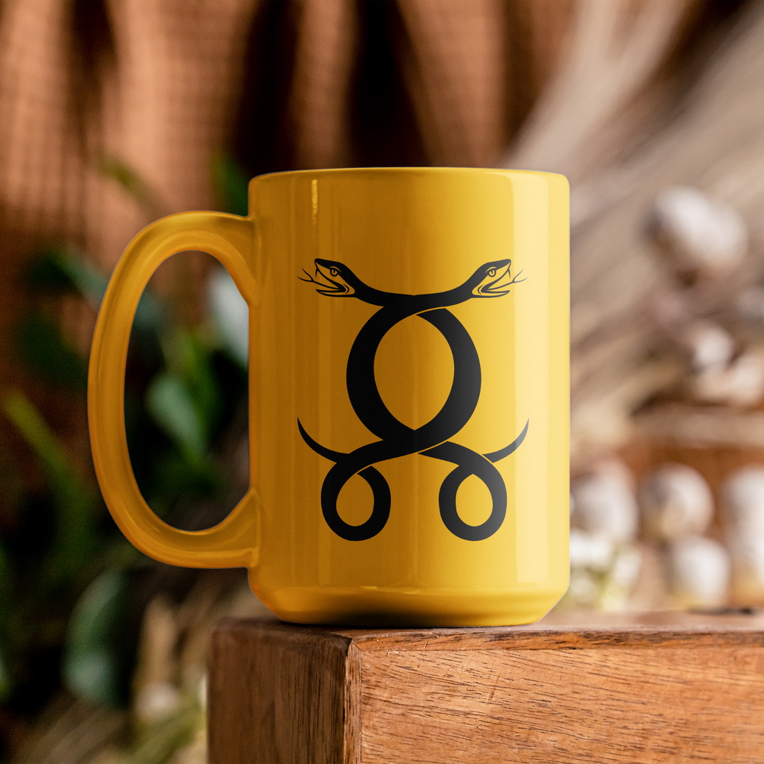 Yellow coffee mug sitting on top of a wooden table.