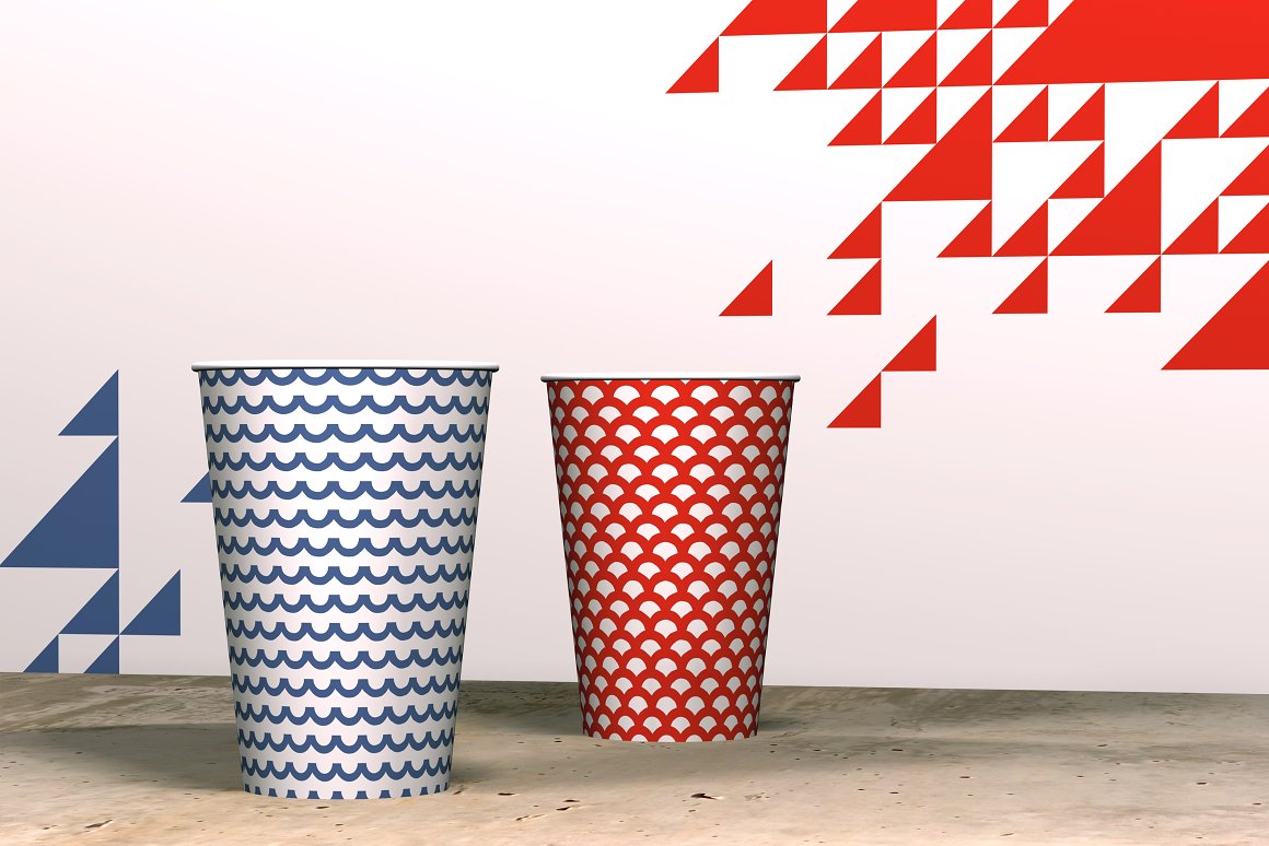 2 white cups with blue and red nautical patterns.