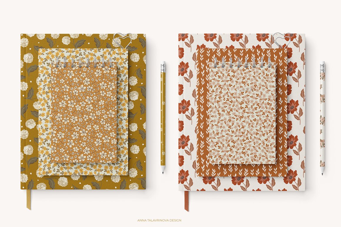 2 notebooks with warm floral patterns on a gray background.