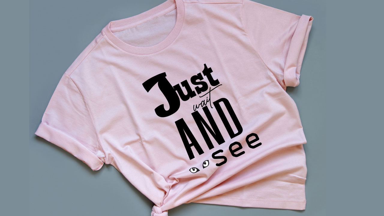 Pink t-shirt with black lettering.