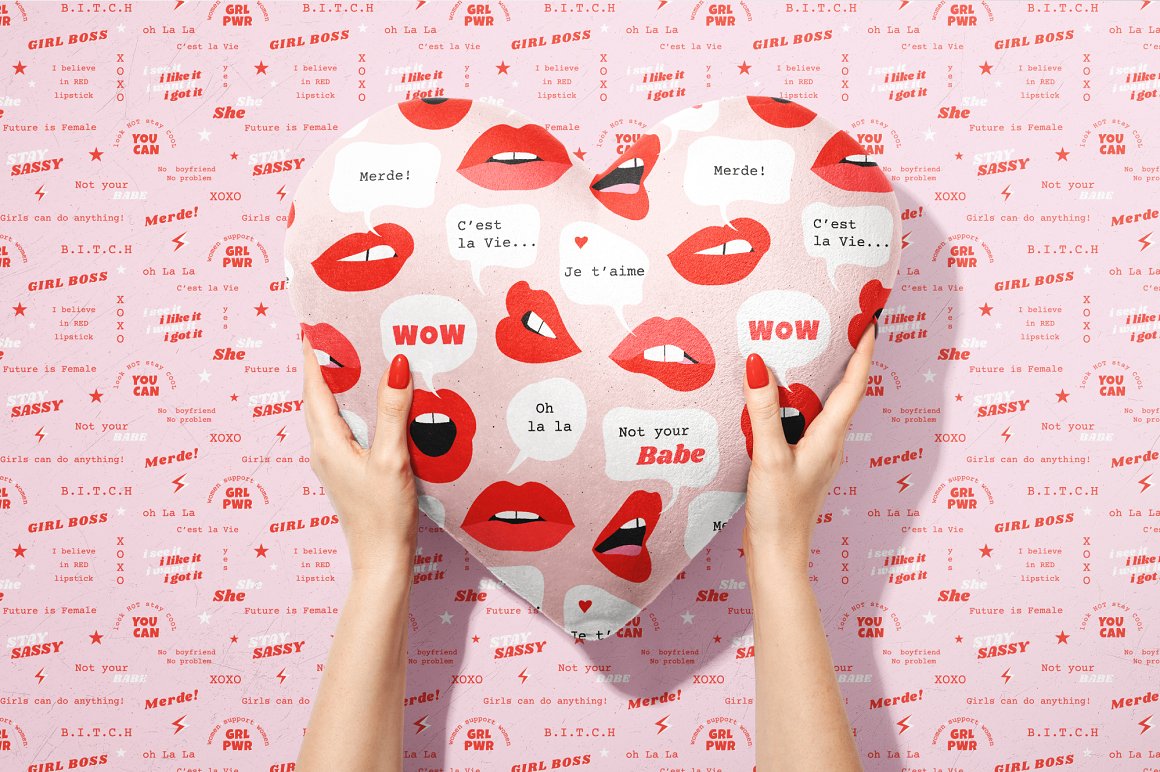 Pink balloon heart with red lips and different quoptes on a pink background with different red lettering.