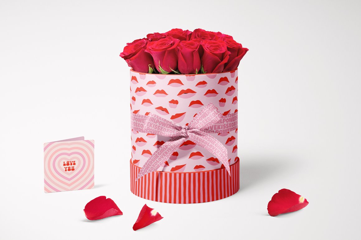 Red roses in the round box with red and pink patterns of lips on a gray background.
