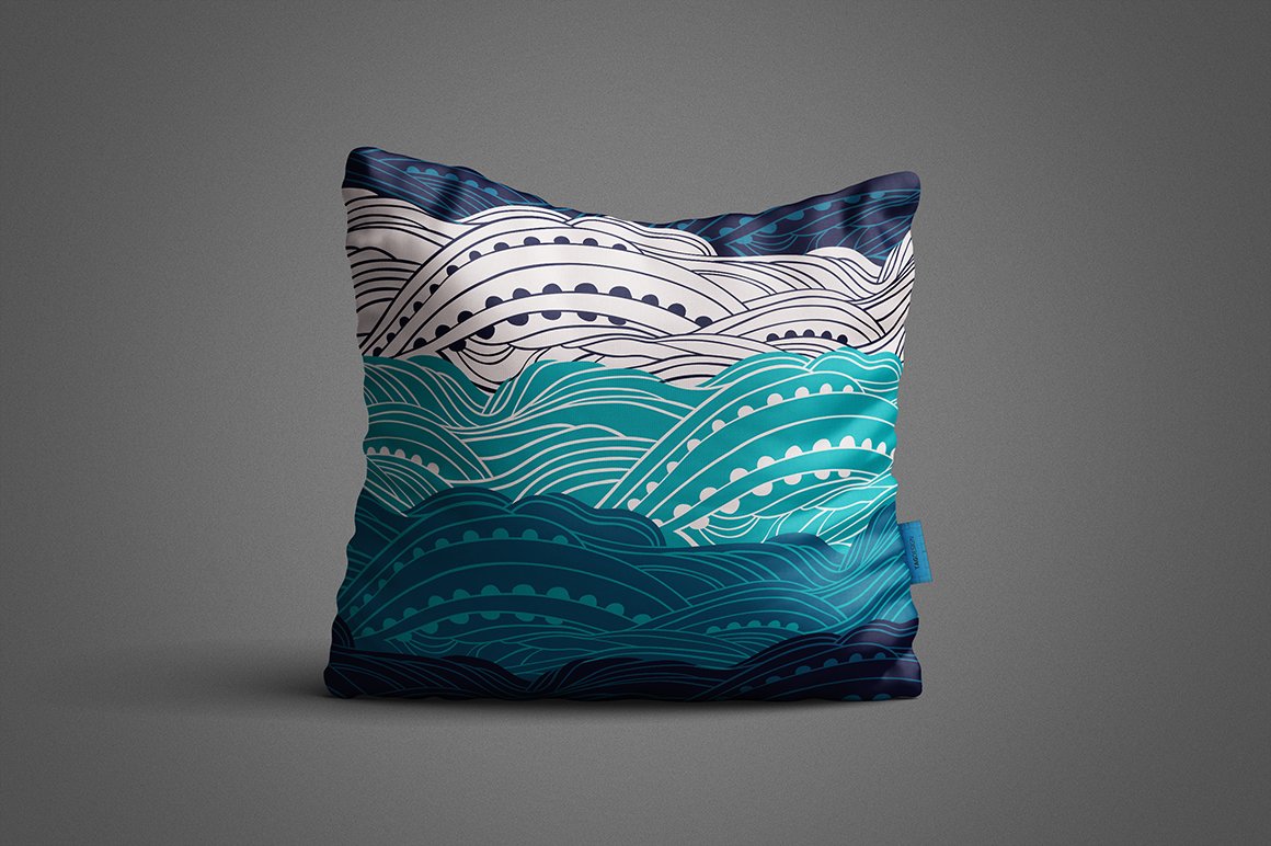 Colorful square pillow with maritime patterns on a gray background.