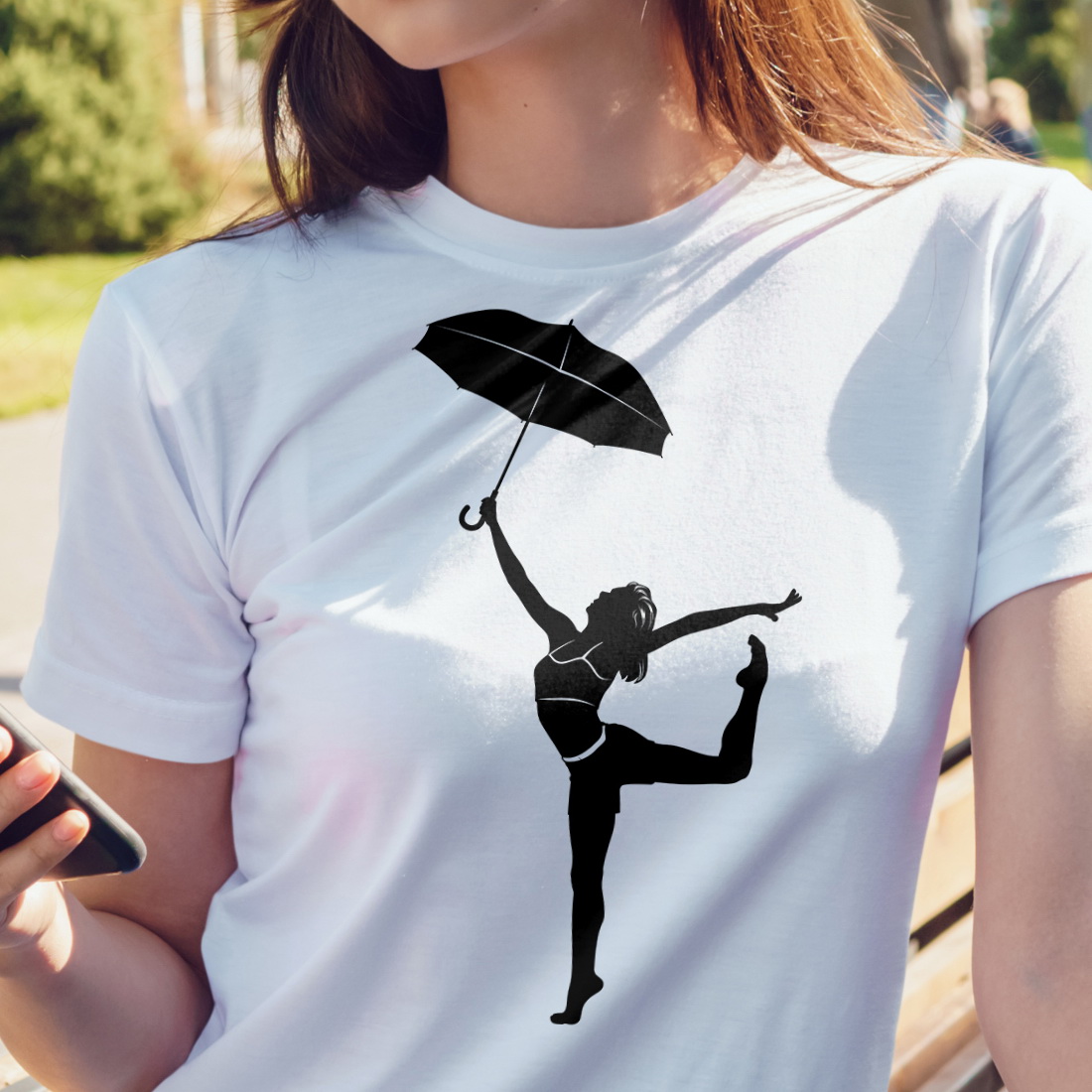 White t-shirt with a dancing woman with an umbrella.