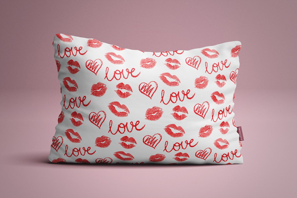 White pillow with patterns of red lettering "Love", heart and lips illustrations.