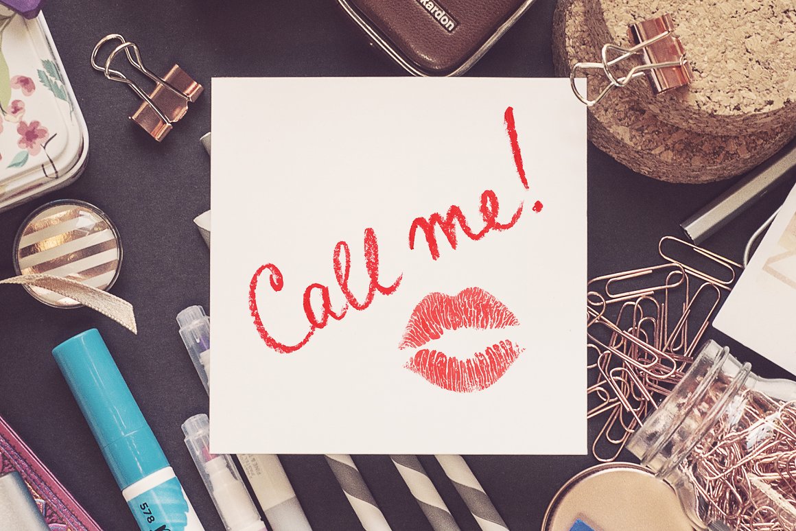 White card with red lettering "Call me!" and red illustration of kisses lips.